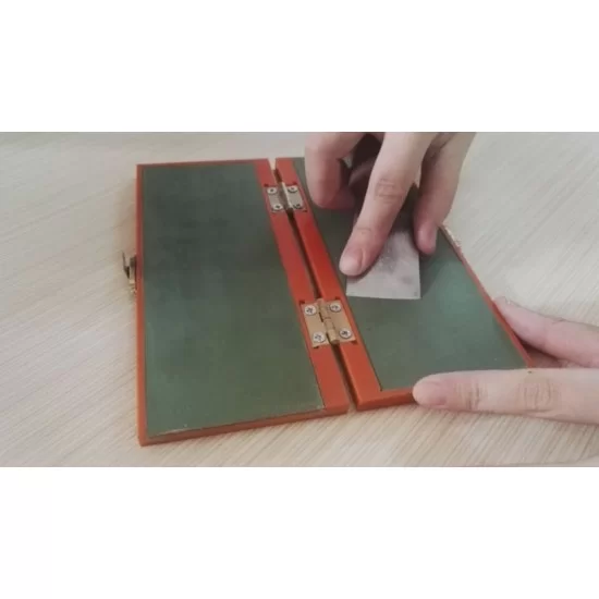 Folded leather strop with jewelers rouge